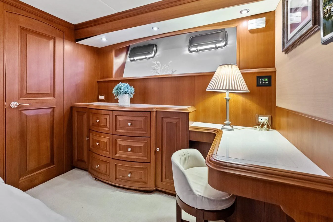 A cozy stateroom featuring elegant wooden cabinetry and a comfortable workspace. aboard EL LEGADO Yacht for Sale
