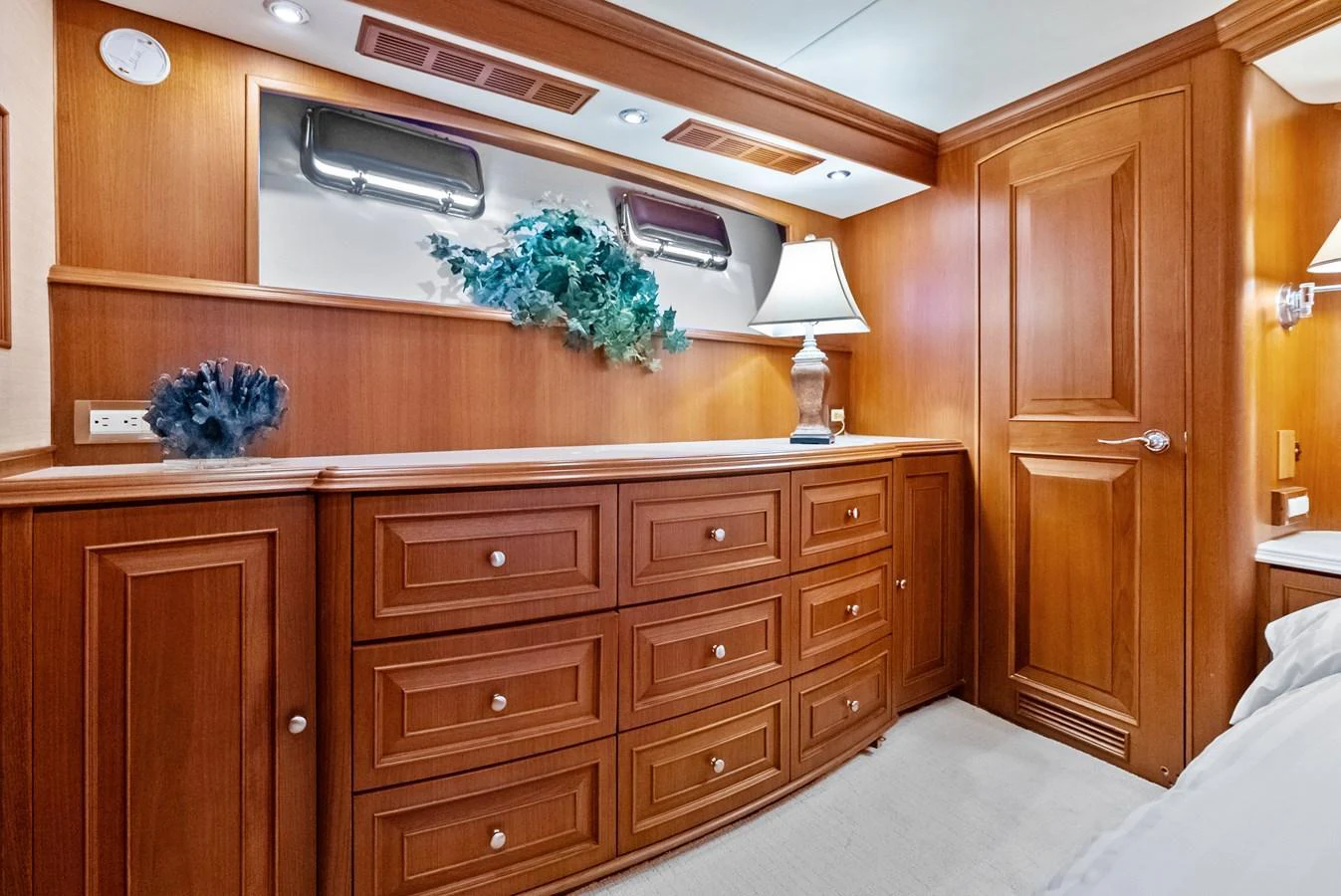 The stateroom features elegant wood cabinetry and soft lighting for a cozy ambiance. aboard EL LEGADO Yacht for Sale