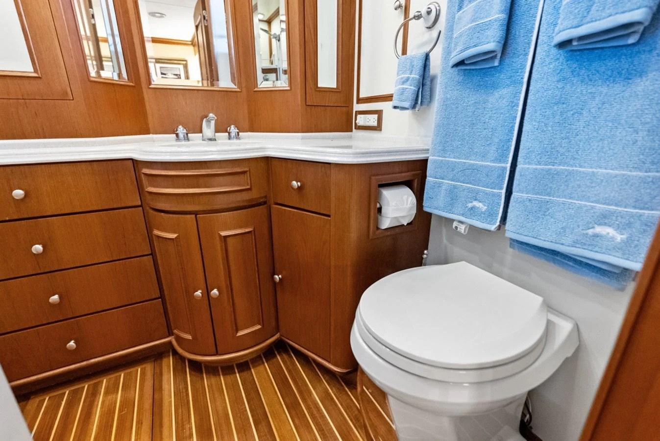 The yacht's bathroom features elegant wooden cabinetry and modern fixtures. aboard EL LEGADO Yacht for Sale
