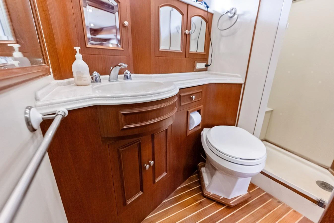 The yacht's bathroom features elegant wooden cabinetry and modern fixtures. aboard EL LEGADO Yacht for Sale