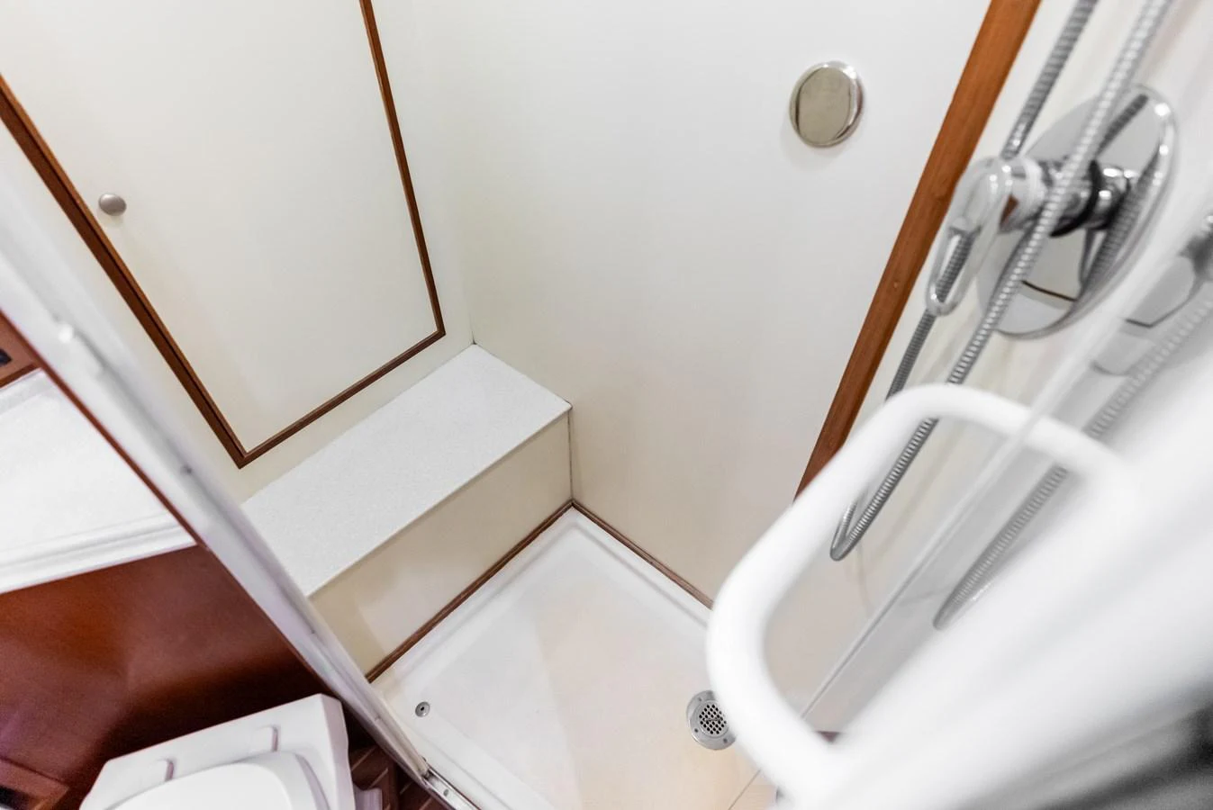 The yacht's bathroom features a compact and functional shower area with clean, modern fixtures. aboard EL LEGADO Yacht for Sale