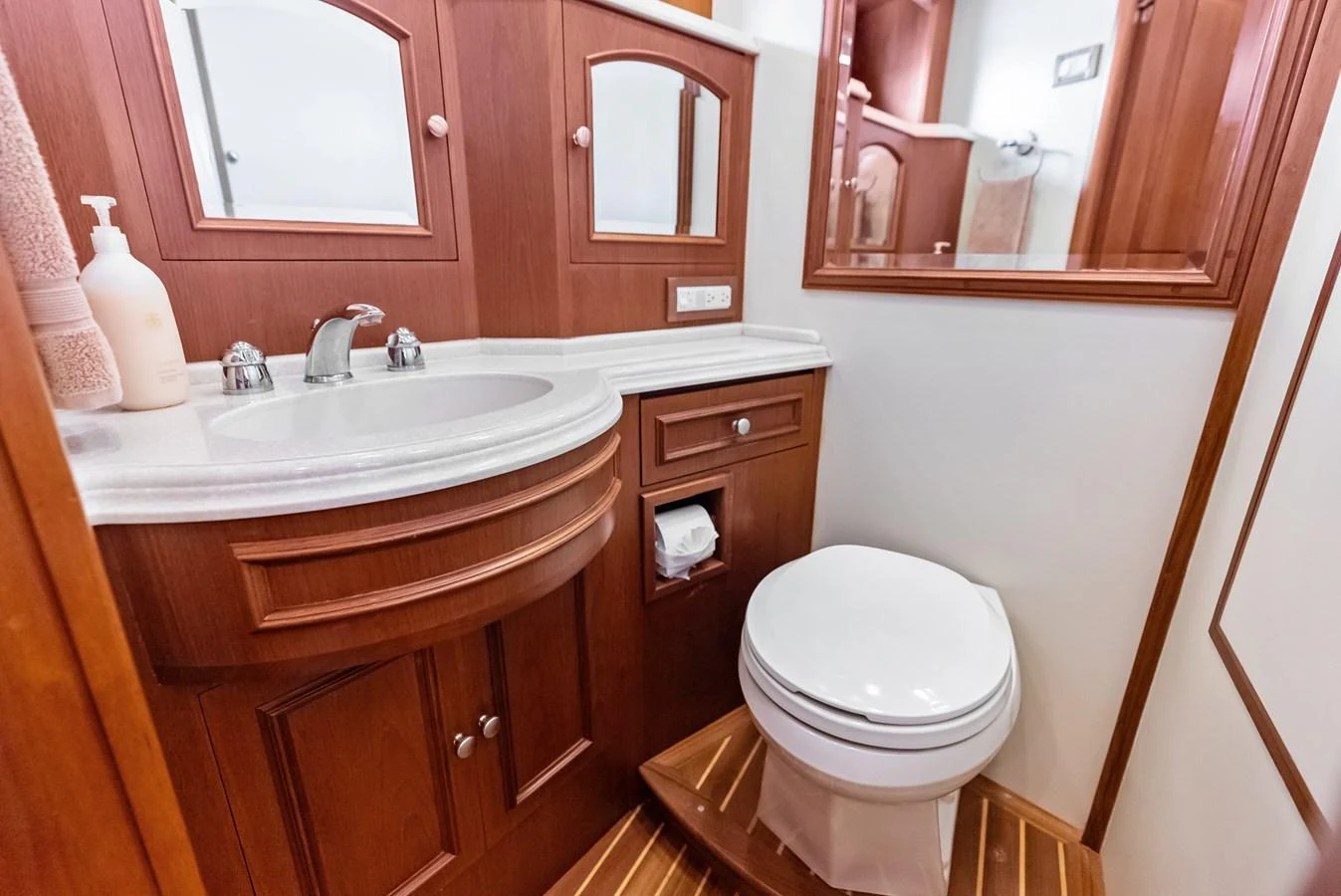 The yacht's bathroom features elegant wooden cabinetry and modern fixtures. aboard EL LEGADO Yacht for Sale