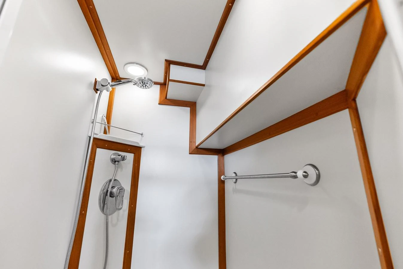 A sleek and modern yacht shower with clean lines and wooden accents. aboard EL LEGADO Yacht for Sale