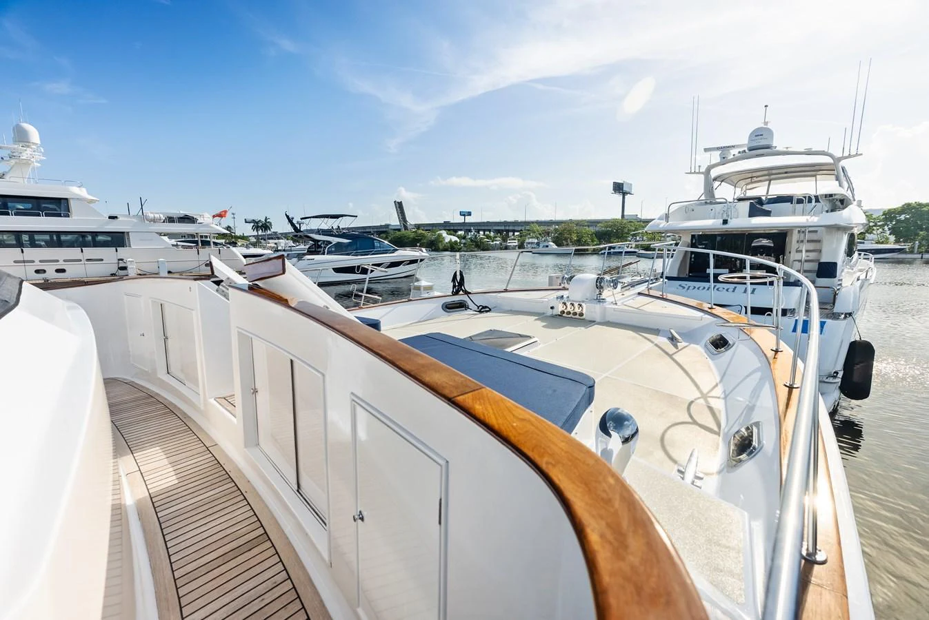 The yacht's deck offers a spacious and inviting area with a beautiful view of the marina. aboard EL LEGADO Yacht for Sale