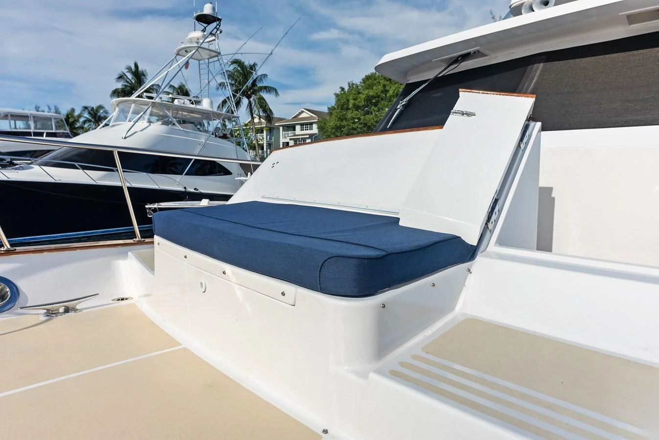 The yacht features a comfortable outdoor seating area with a blue cushion, perfect for relaxation. aboard EL LEGADO Yacht for Sale