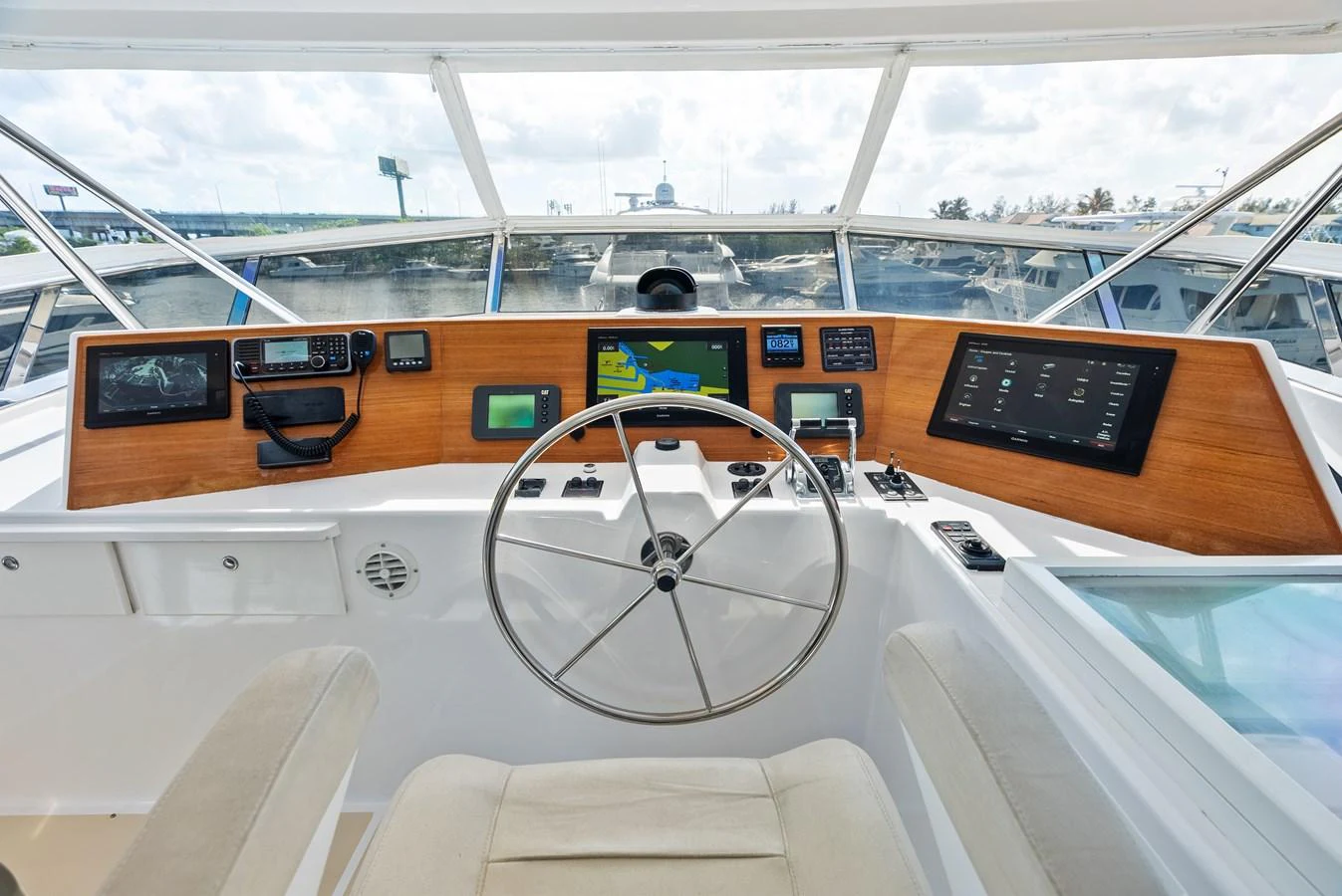 The helm station features a modern dashboard with advanced navigation equipment and a comfortable captain's chair. aboard EL LEGADO Yacht for Sale