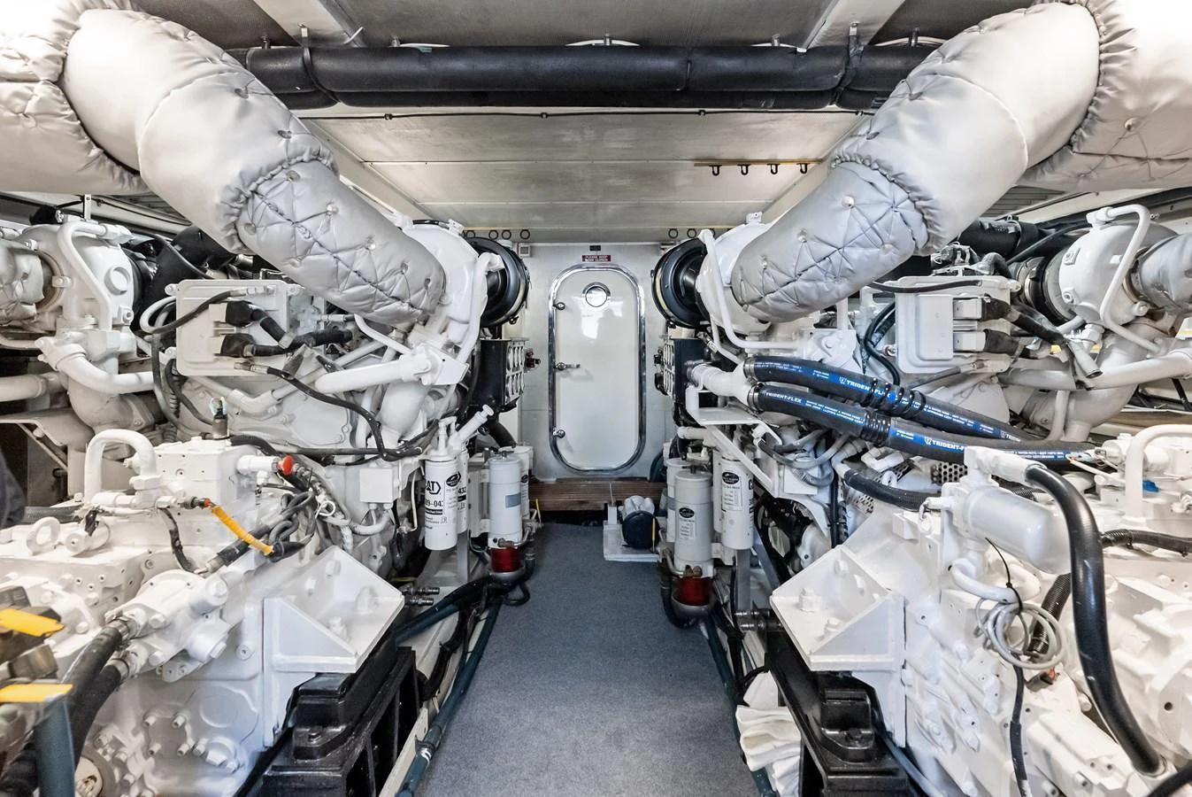 The image showcases the meticulously maintained engine room of the yacht, featuring advanced machinery and clean installations. aboard EL LEGADO Yacht for Sale