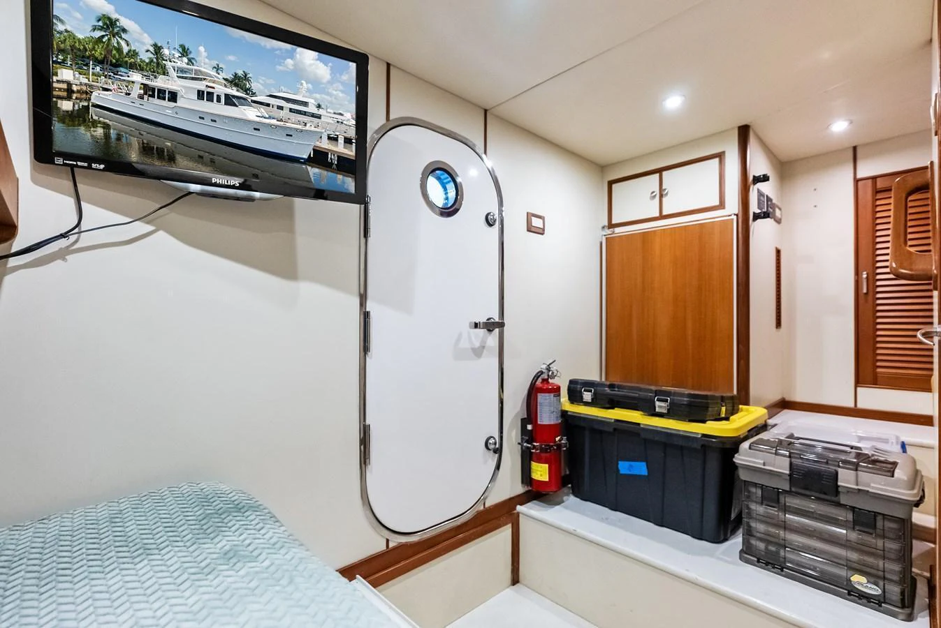 A cozy cabin with practical storage solutions and a mounted television. aboard EL LEGADO Yacht for Sale