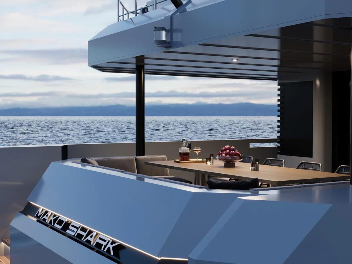 The aft deck offers a luxurious outdoor dining area with stunning ocean views. aboard MAKO SHARK Yacht for Sale