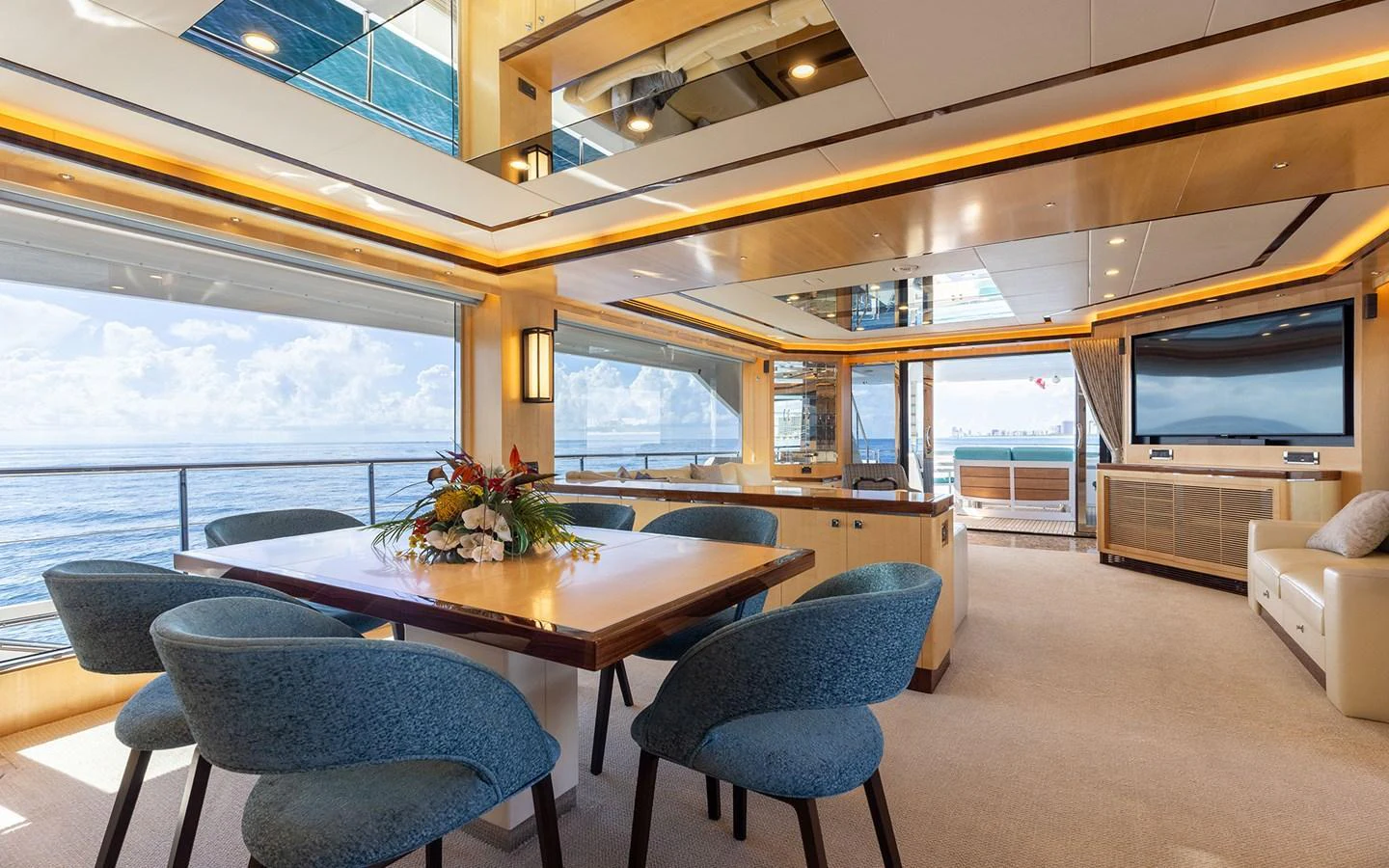 The yacht's dining area features elegant seating with panoramic ocean views. aboard WADDLE WE DO Yacht for Sale