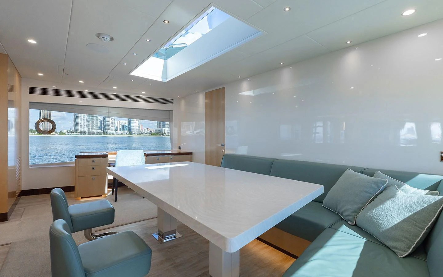 The salon features a modern dining area with ample natural light and comfortable seating. aboard WADDLE WE DO Yacht for Sale