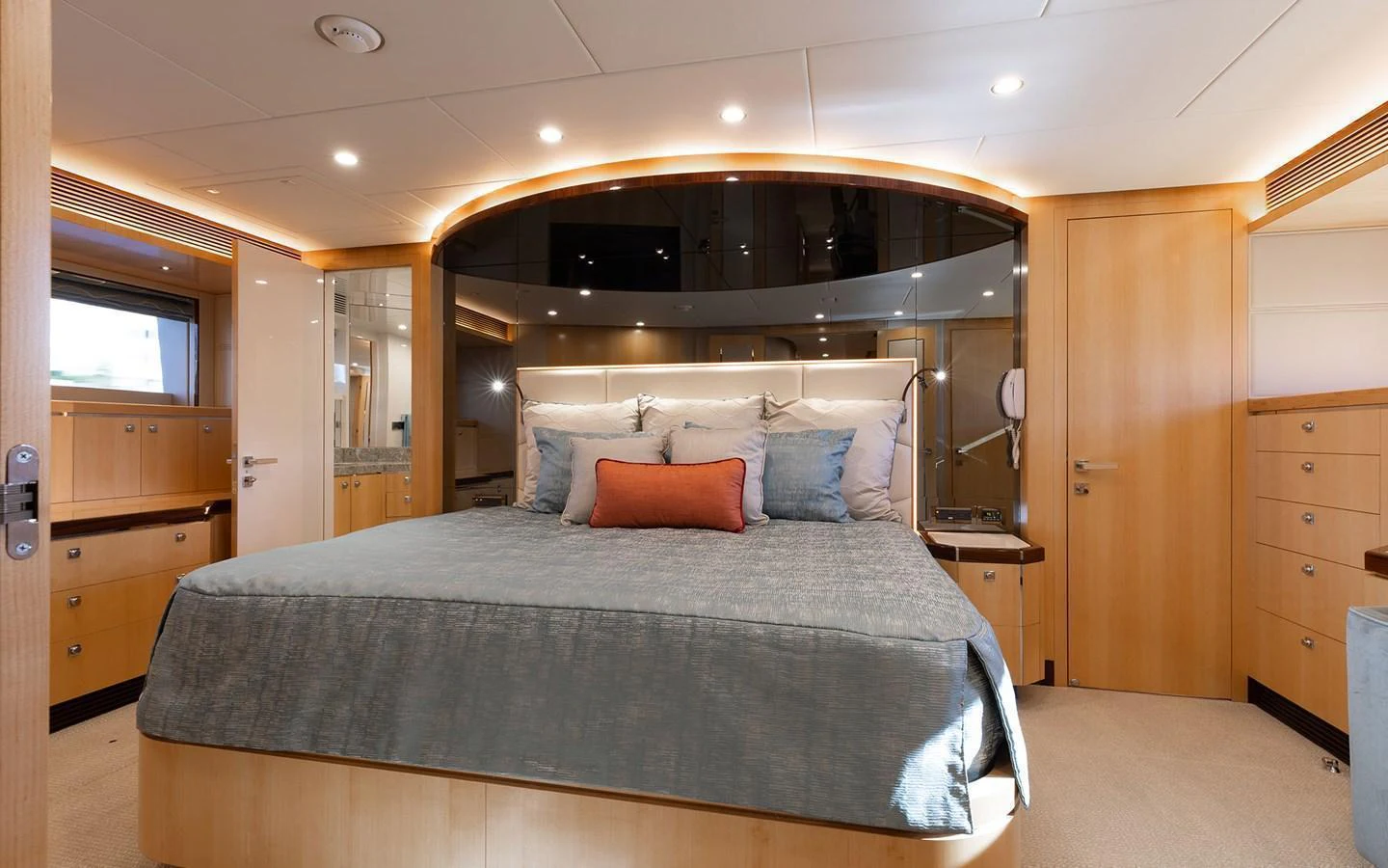 The master stateroom features a spacious bed with elegant wood finishes and modern lighting. aboard WADDLE WE DO Yacht for Sale