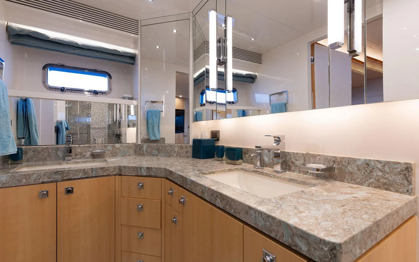 The yacht's bathroom features a luxurious marble countertop and modern fixtures. aboard WADDLE WE DO Yacht for Sale