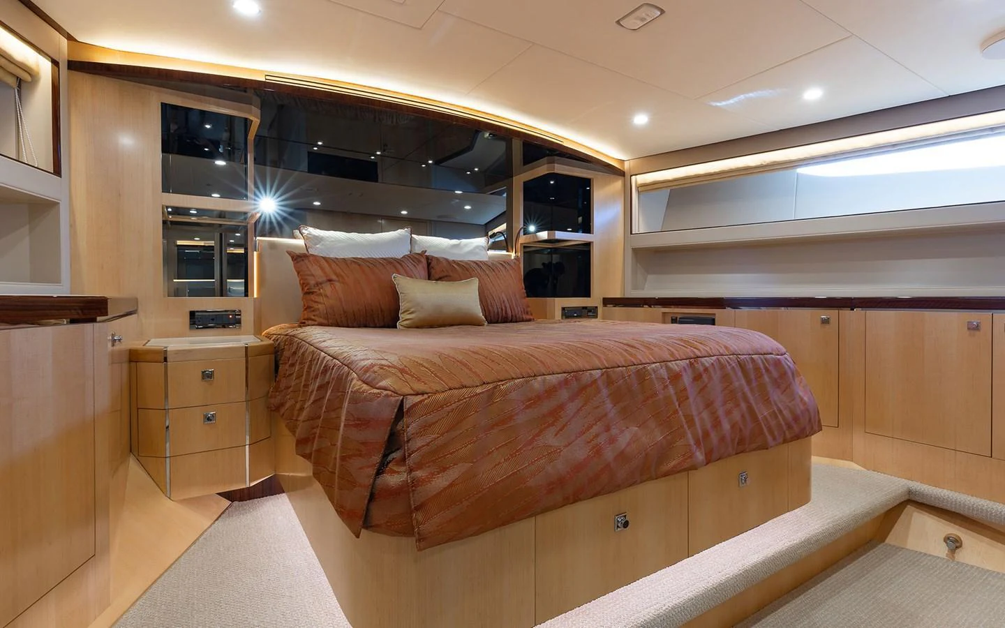 The master stateroom features a luxurious bed with elegant bedding and ample storage space. aboard WADDLE WE DO Yacht for Sale