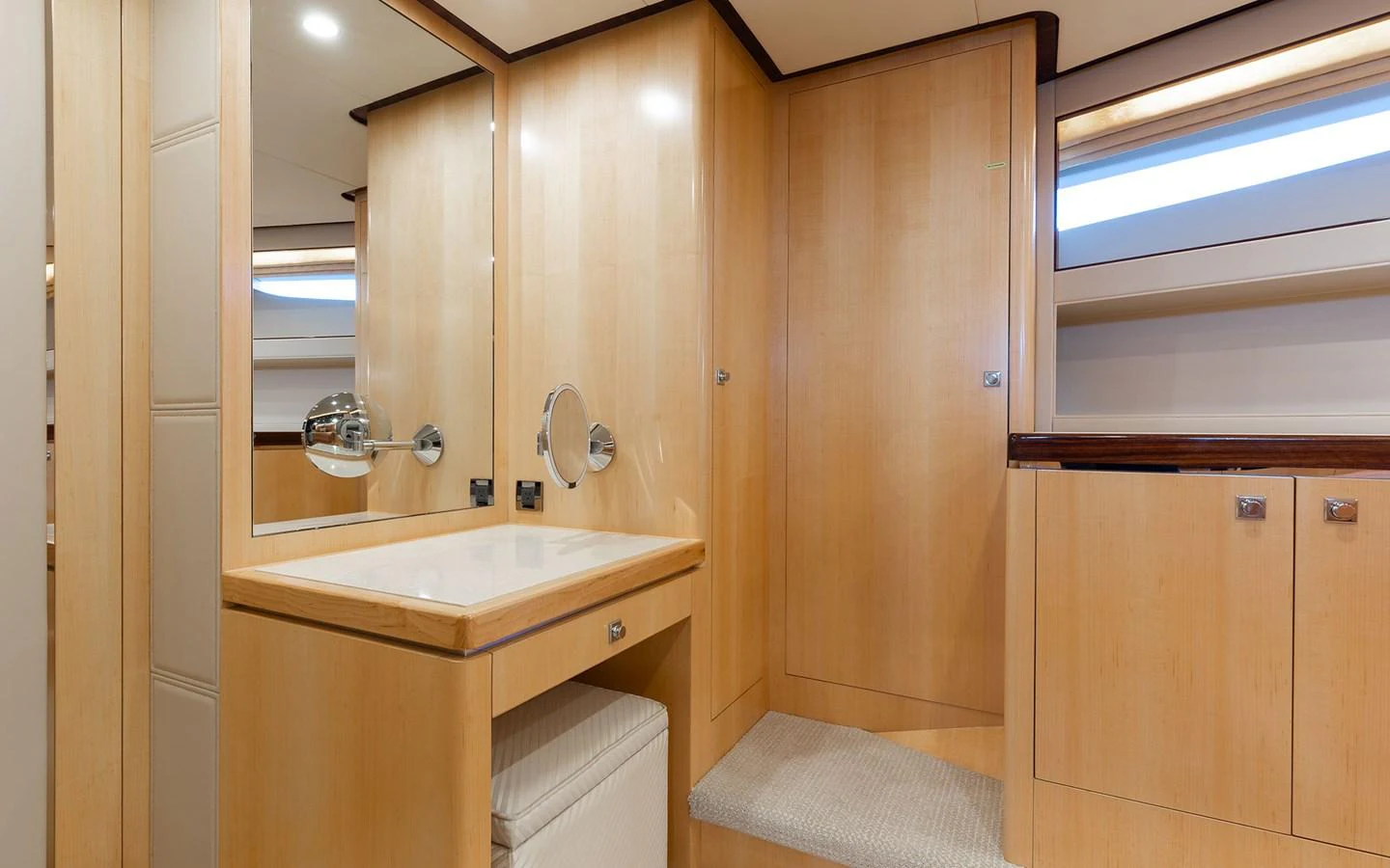 The yacht's bathroom features sleek wooden cabinetry and a modern sink area. aboard WADDLE WE DO Yacht for Sale