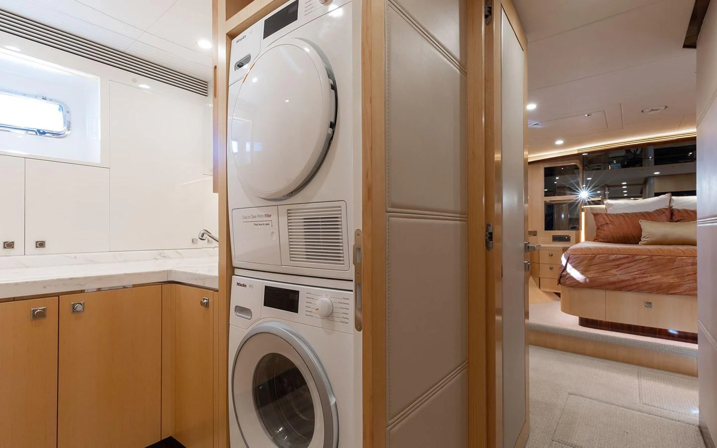 The yacht's interior features a well-equipped laundry area adjacent to a cozy stateroom. aboard WADDLE WE DO Yacht for Sale