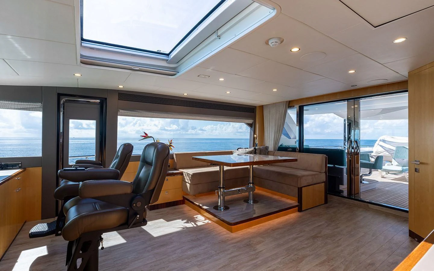 The salon features luxurious seating, a dining area, and large windows offering stunning ocean views. aboard WADDLE WE DO Yacht for Sale