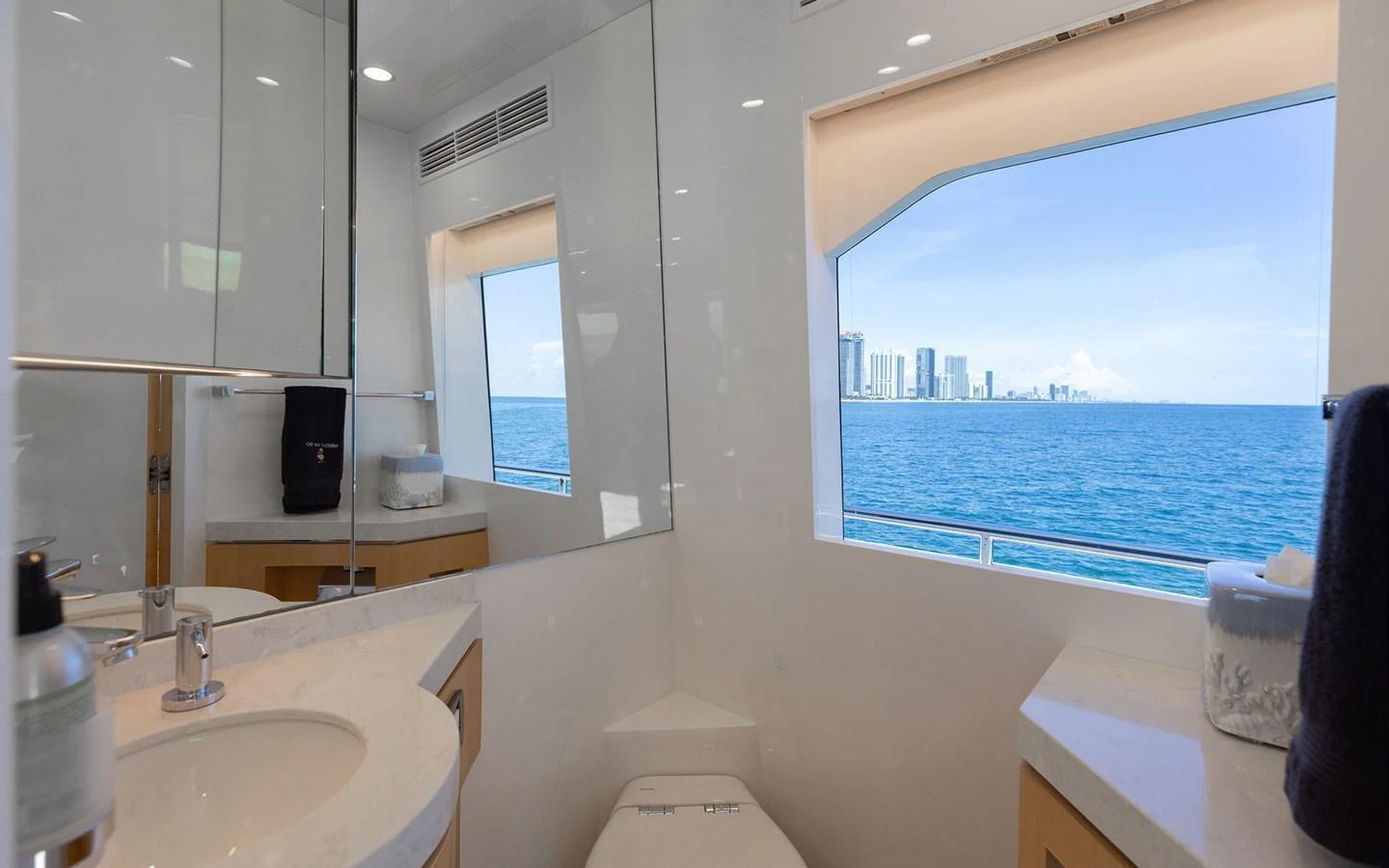 A modern yacht bathroom with a large window offering a stunning ocean view. aboard WADDLE WE DO Yacht for Sale