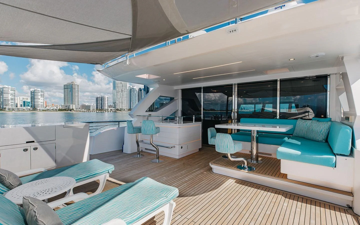 The aft deck offers a spacious and stylish outdoor seating area with a stunning view of the city skyline. aboard WADDLE WE DO Yacht for Sale