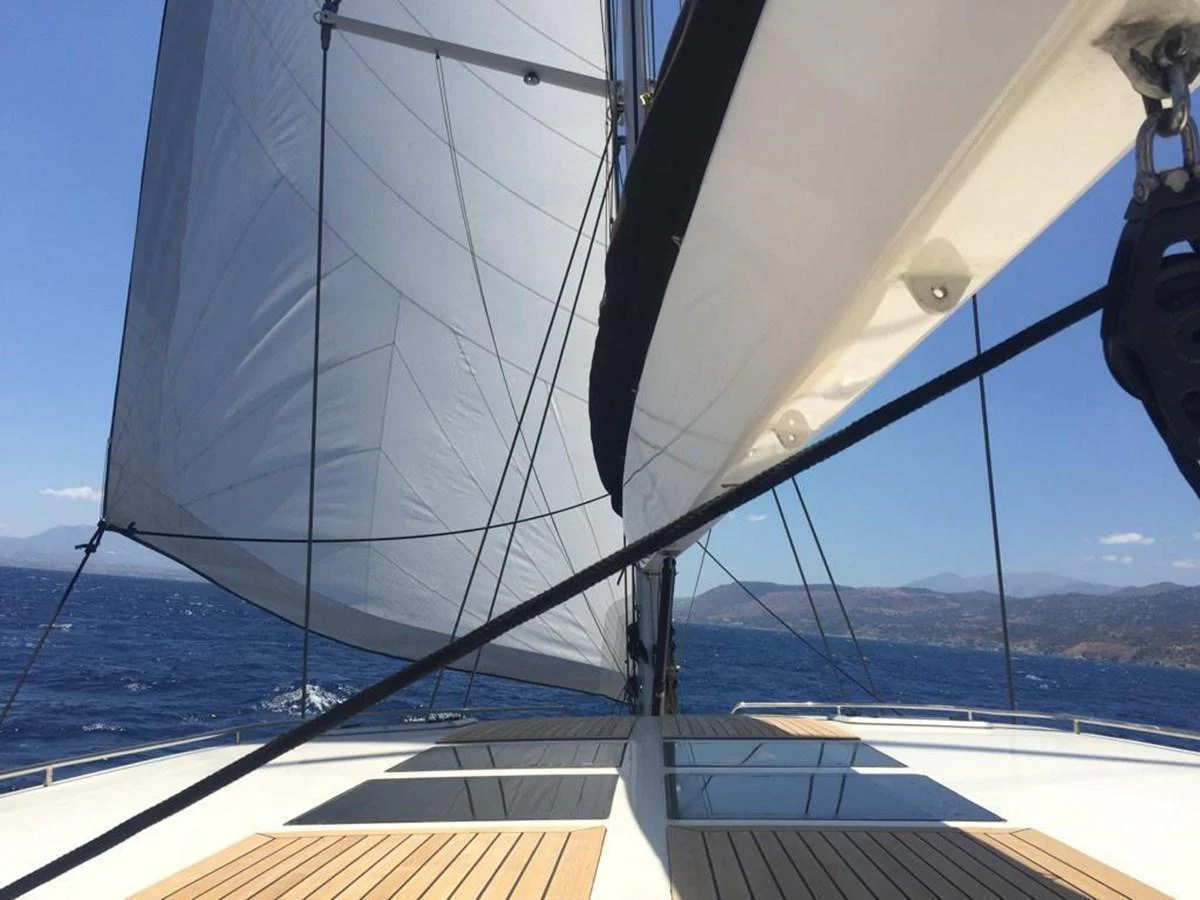 The yacht is sailing with its sails fully deployed, showcasing a sleek and modern deck design. aboard 23 M MOTORSAILOR Yacht for Sale