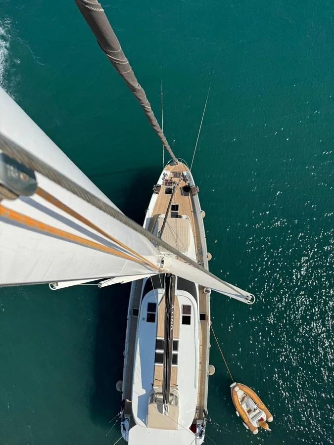 A stunning aerial view of a yacht's mast and deck, showcasing its sleek design and the surrounding blue waters. aboard 23 M MOTORSAILOR Yacht for Sale