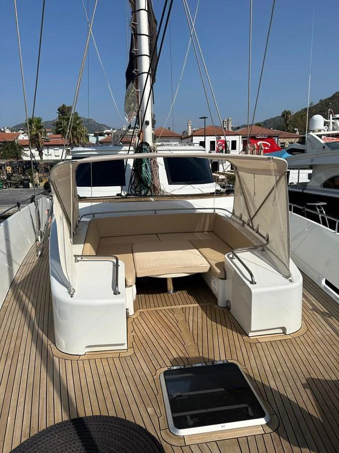 The foredeck features a cozy seating area with a sunshade, perfect for relaxation. aboard 23 M MOTORSAILOR Yacht for Sale