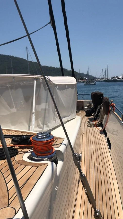 The side deck of the yacht offers a sleek and inviting passageway with a view of the marina. aboard 23 M MOTORSAILOR Yacht for Sale