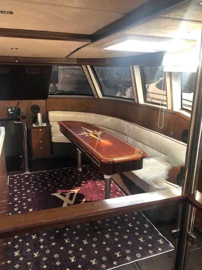 The saloon features a stylish dining area with a polished wooden table and plush seating. aboard 23 M MOTORSAILOR Yacht for Sale