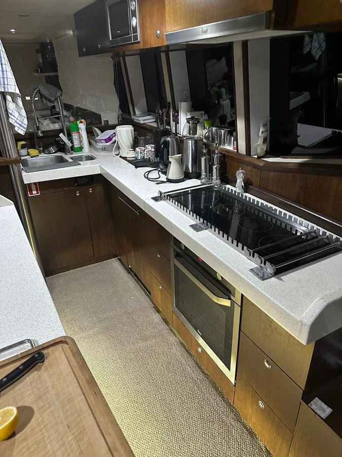 The yacht's galley is equipped with modern appliances and ample counter space for meal preparation. aboard 23 M MOTORSAILOR Yacht for Sale