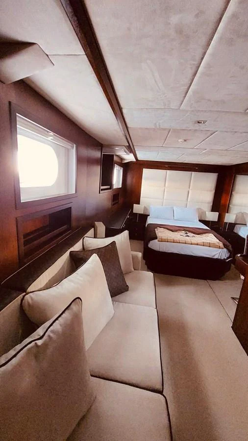 The stateroom features a cozy bed, plush seating, and elegant wood paneling, creating a warm and inviting atmosphere. aboard 23 M MOTORSAILOR Yacht for Sale