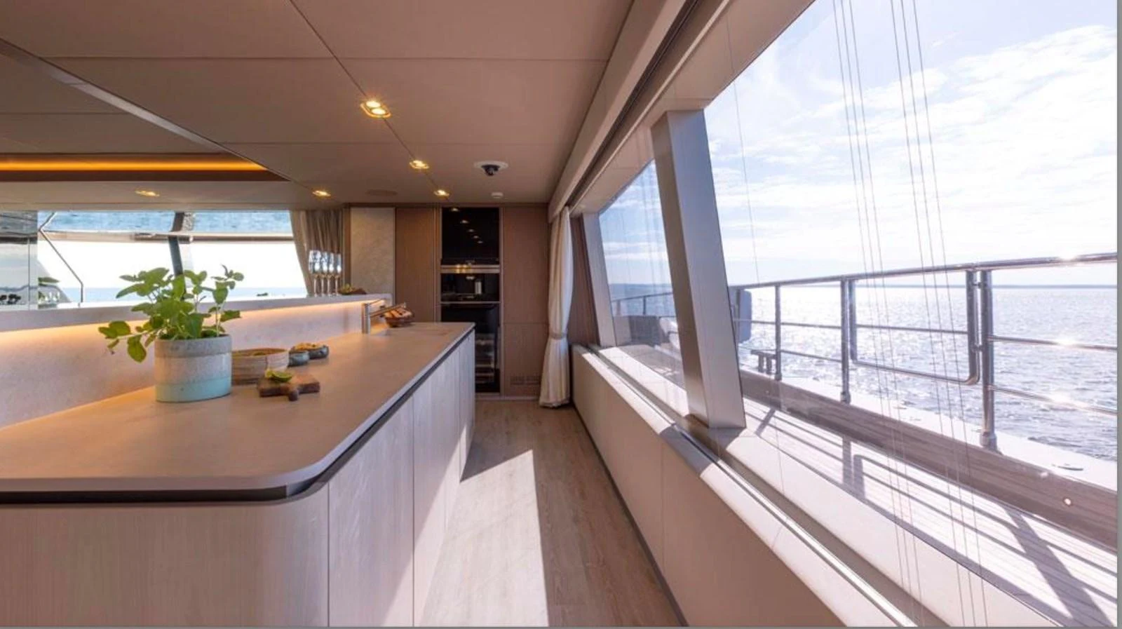 The yacht's galley features modern design with large windows offering stunning ocean views. aboard TWILIGHT Yacht for Sale