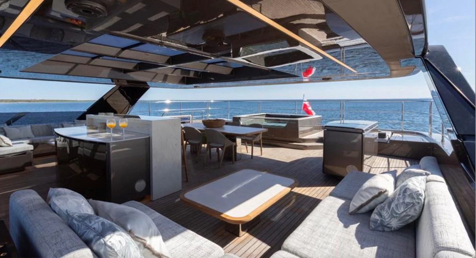 The sundeck offers a luxurious space with ample seating, a bar, and a hot tub, perfect for relaxation and entertainment. aboard TWILIGHT Yacht for Sale