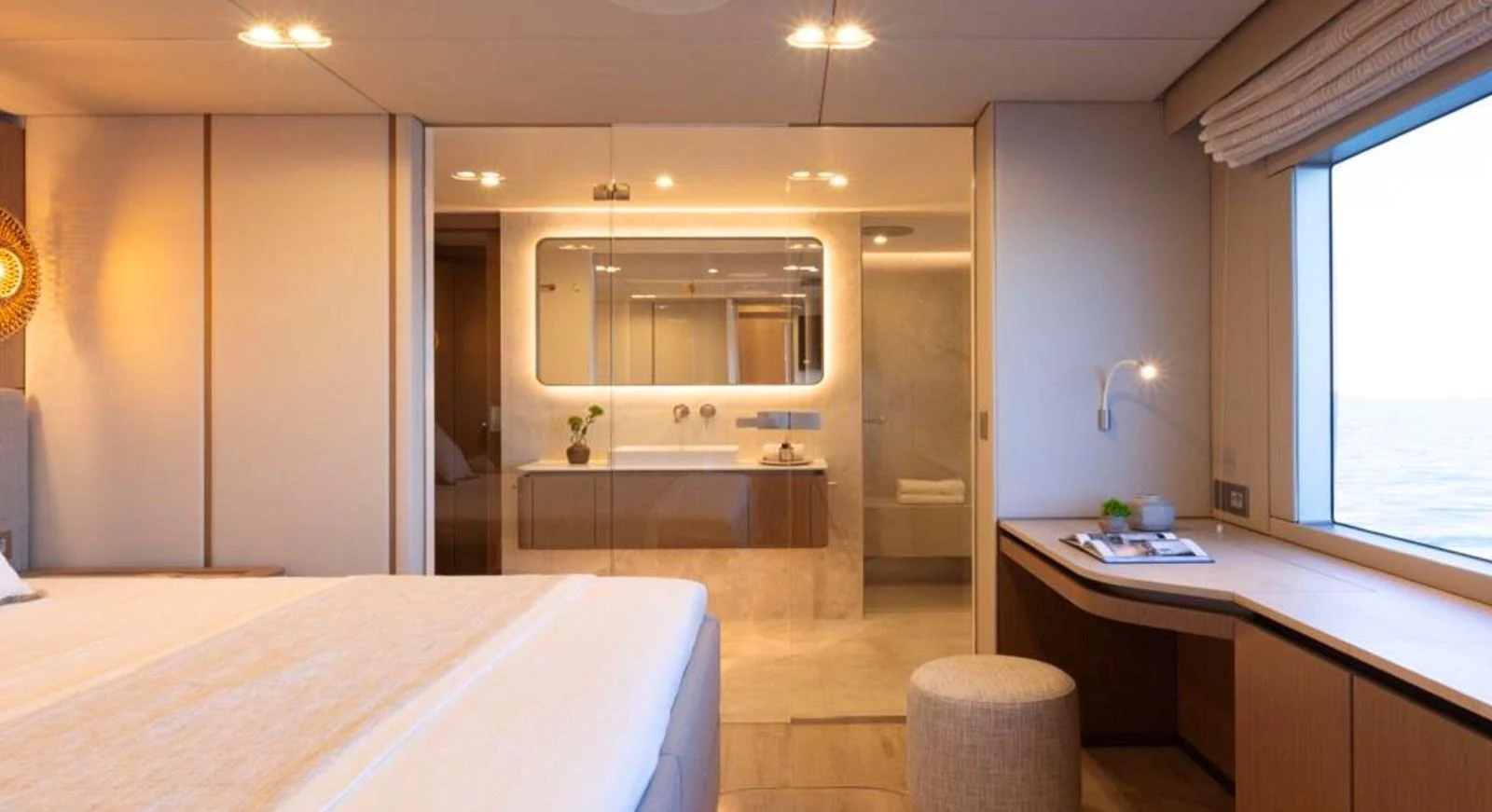 A luxurious stateroom with a large bed, desk, and an ensuite bathroom featuring modern fixtures. aboard TWILIGHT Yacht for Sale
