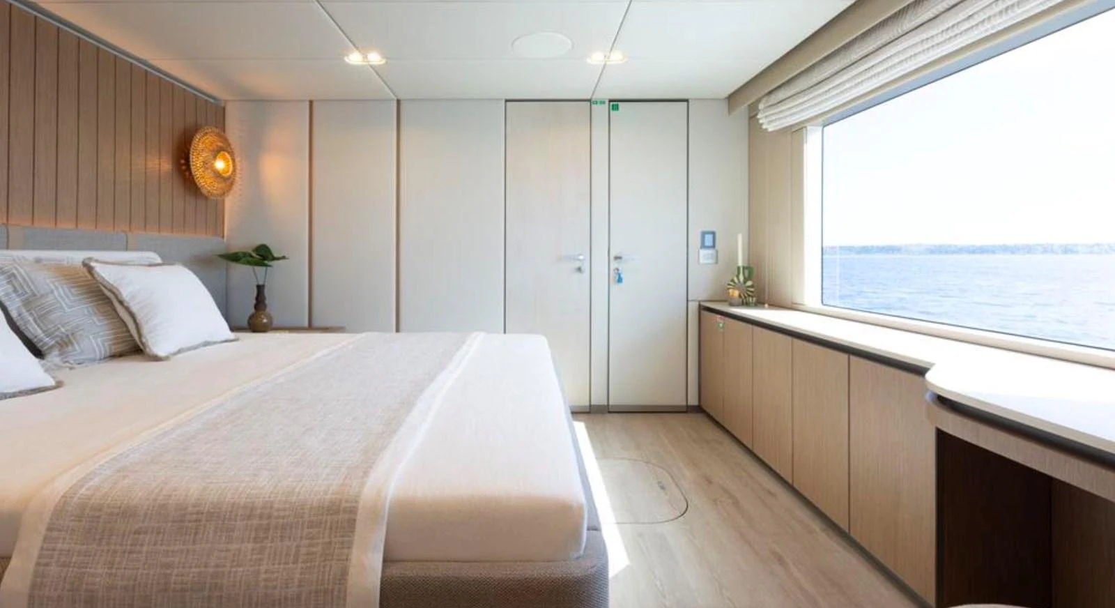 The master stateroom offers a serene and spacious retreat with a large window providing stunning ocean views. aboard TWILIGHT Yacht for Sale