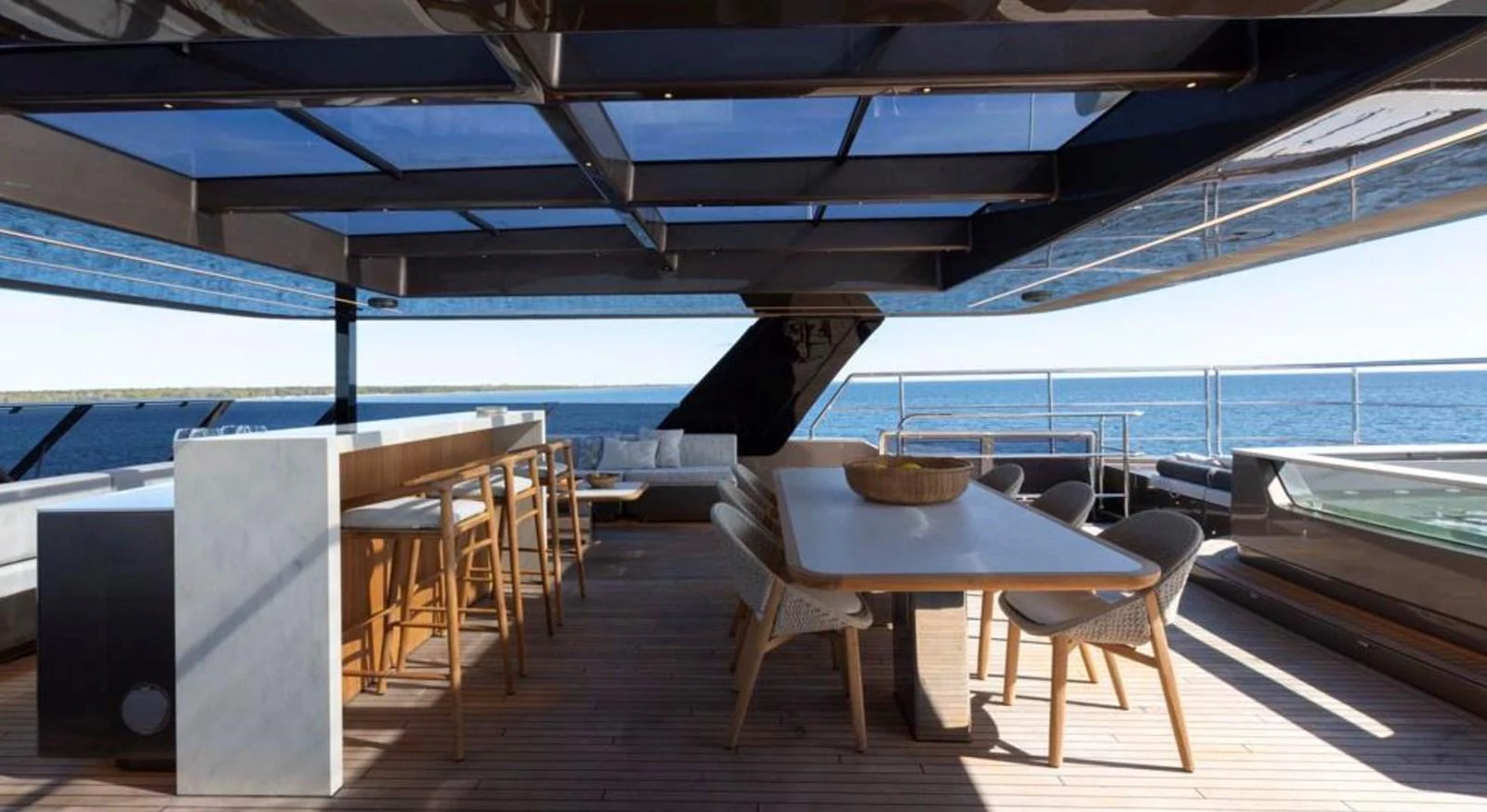 The yacht features a stylish alfresco dining area with a bar and panoramic ocean views. aboard TWILIGHT Yacht for Sale