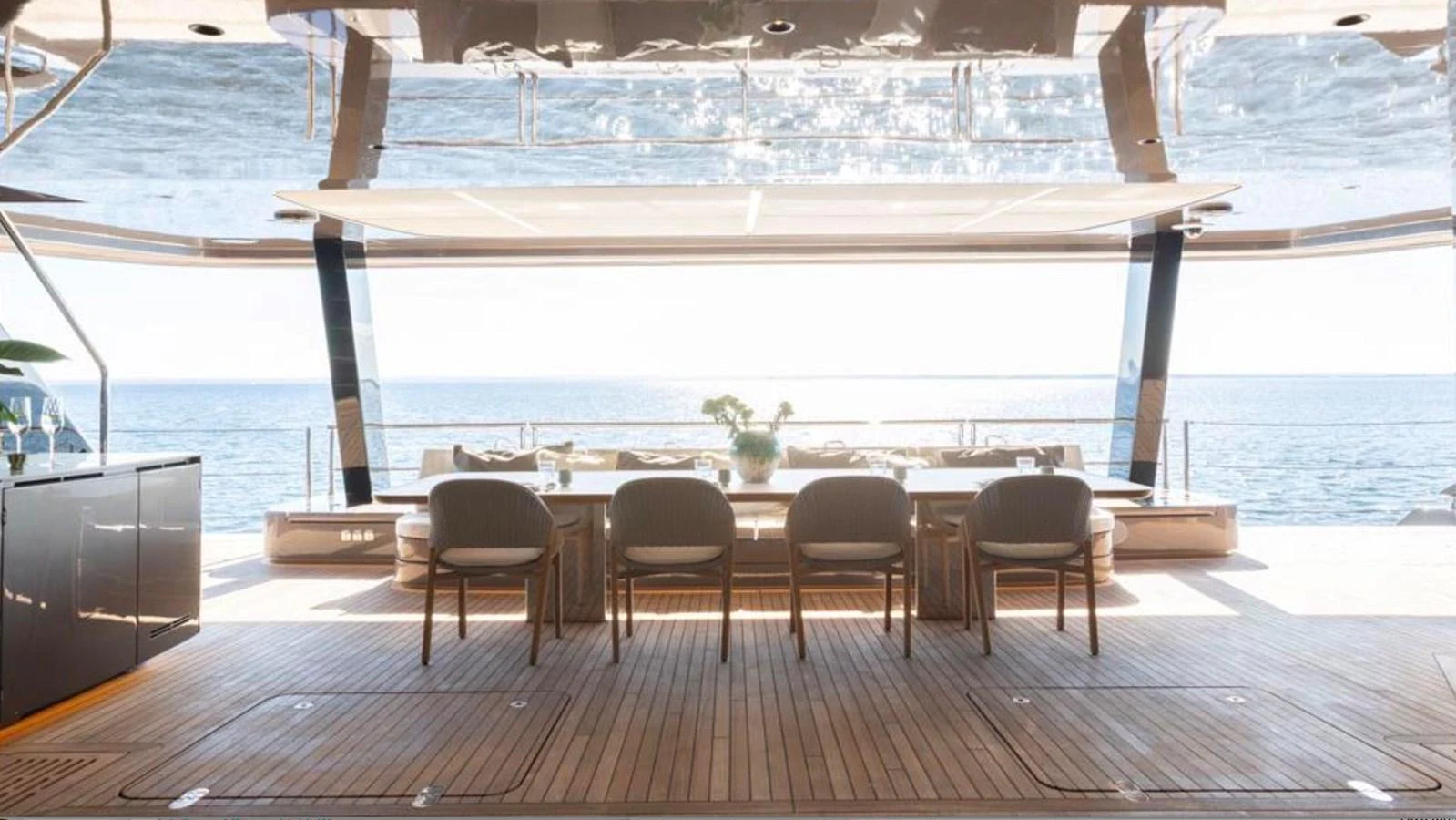 The aft deck offers a luxurious dining area with a stunning ocean view. aboard TWILIGHT Yacht for Sale