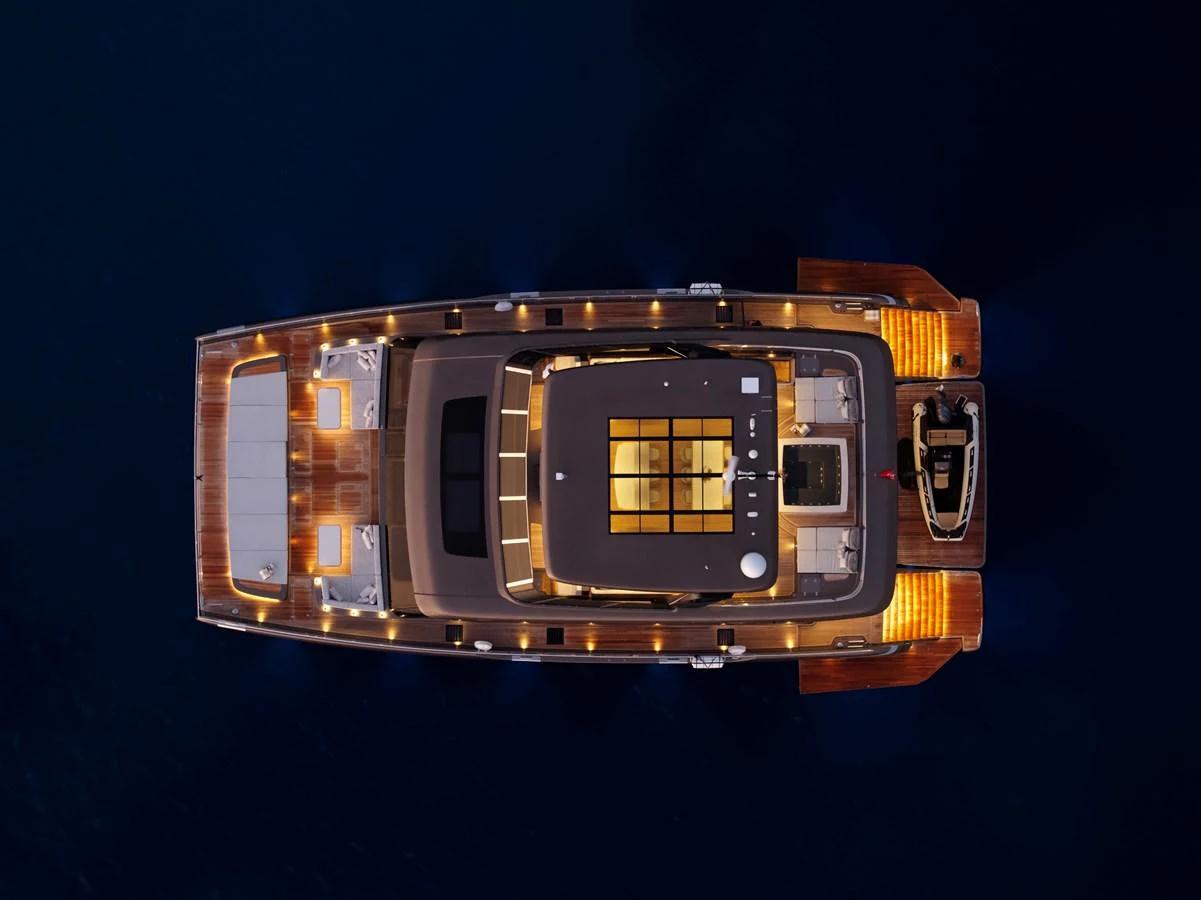 An aerial view of a yacht illuminated beautifully against the dark water. aboard TWILIGHT Yacht for Sale