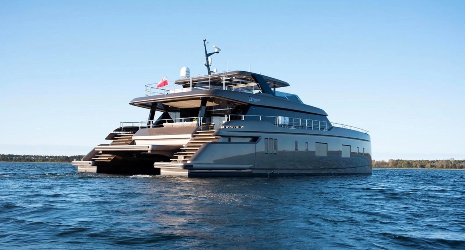 A sleek and modern yacht cruising on calm waters under a clear sky. aboard TWILIGHT Yacht for Sale