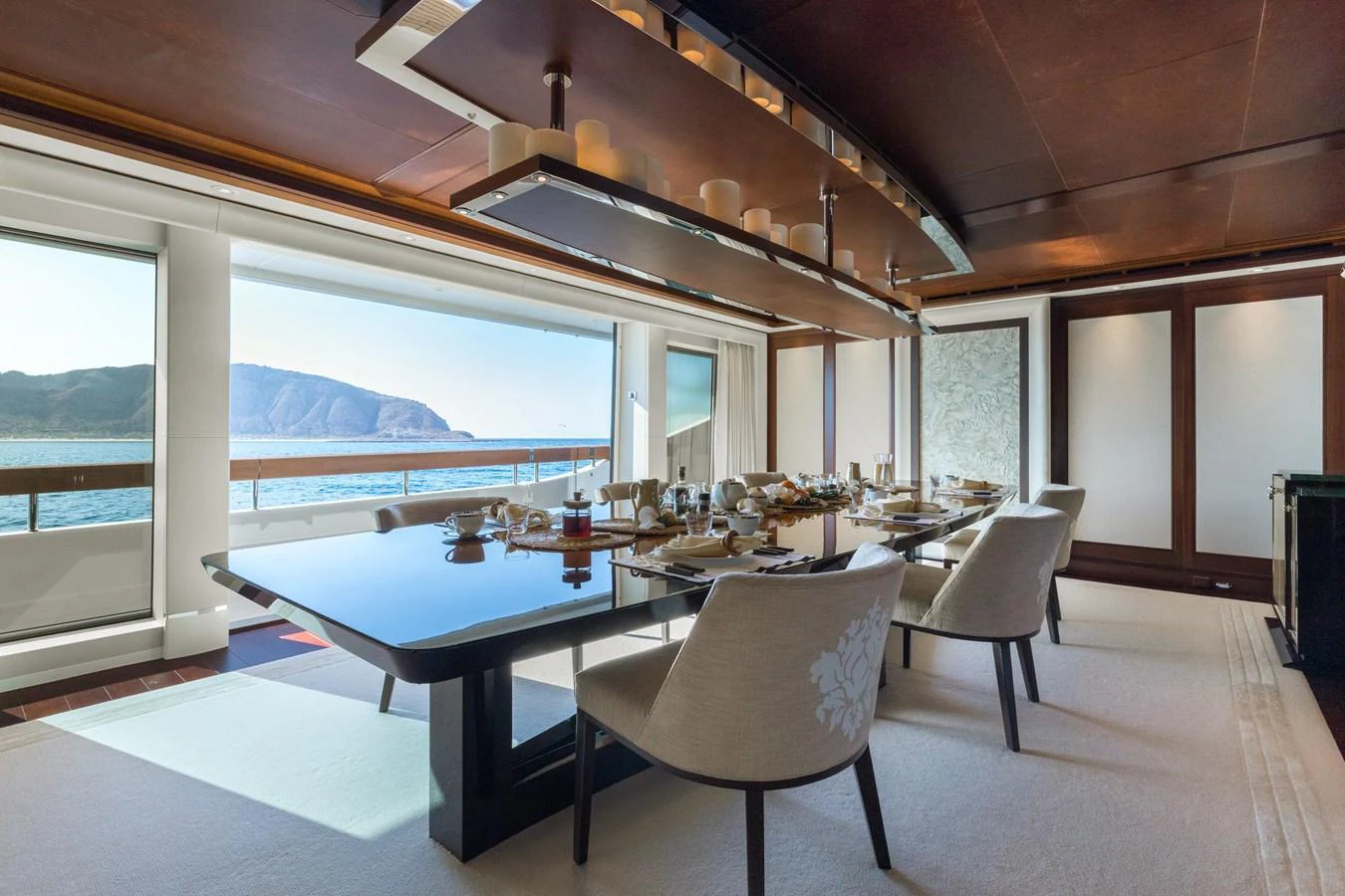 The yacht's elegant dining area offers a luxurious setting with stunning ocean views. aboard HAMPSHIRE Yacht for Sale