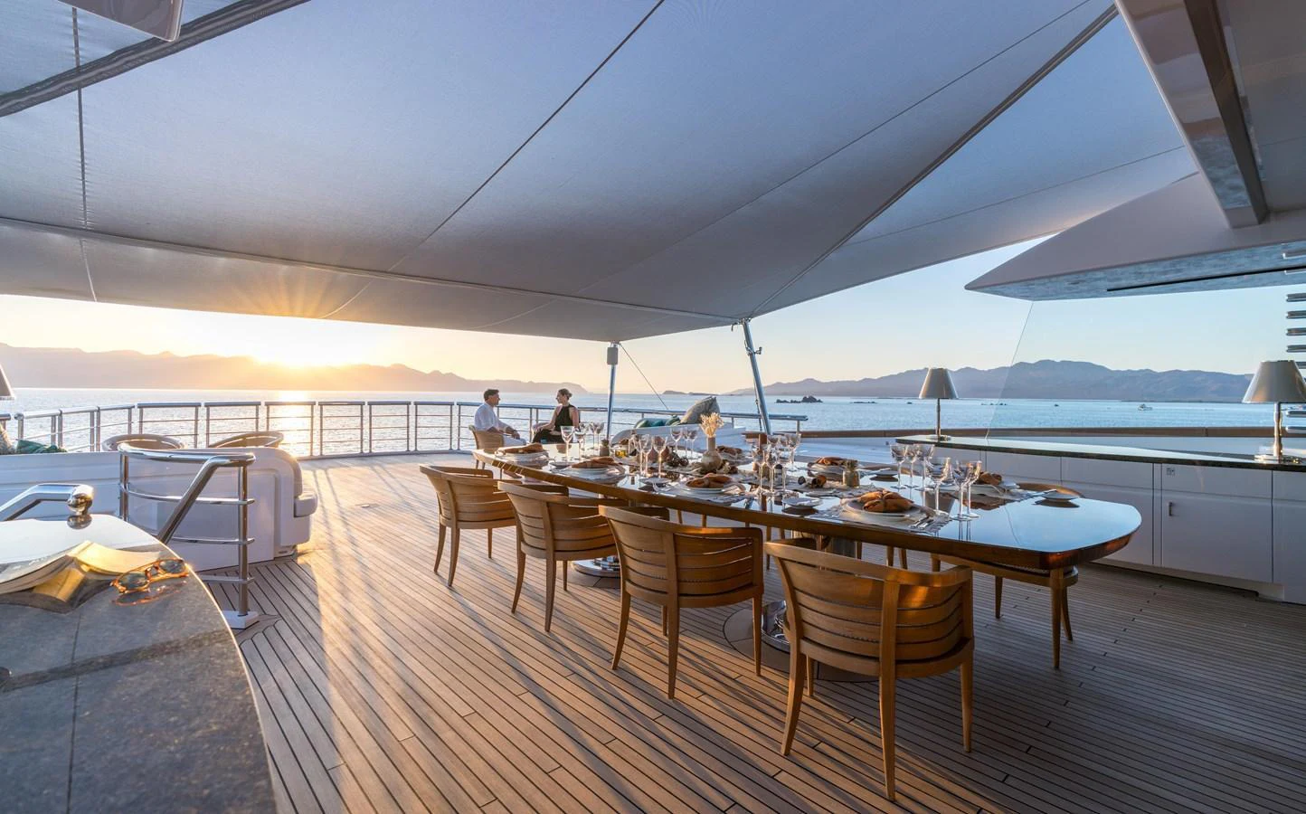 The aft deck features an elegant dining area with a stunning ocean view, perfect for al fresco meals. aboard HAMPSHIRE Yacht for Sale