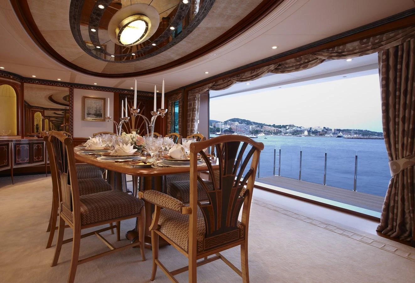 The elegant dining area offers a luxurious setting with a stunning view of the water. aboard LADY CHRISTINE Yacht for Sale