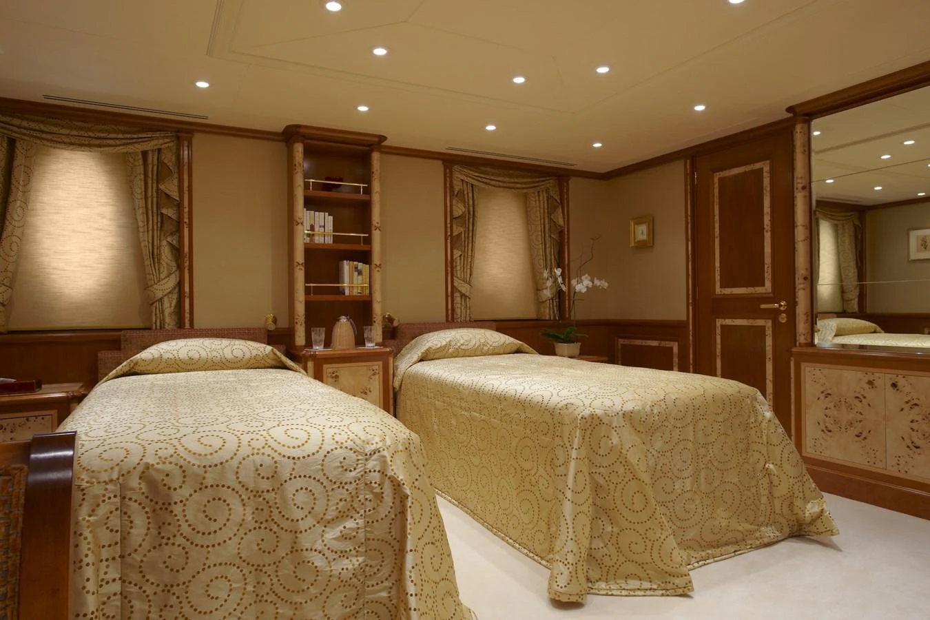The guest stateroom features twin beds with elegant bedding and warm wooden accents. aboard LADY CHRISTINE Yacht for Sale