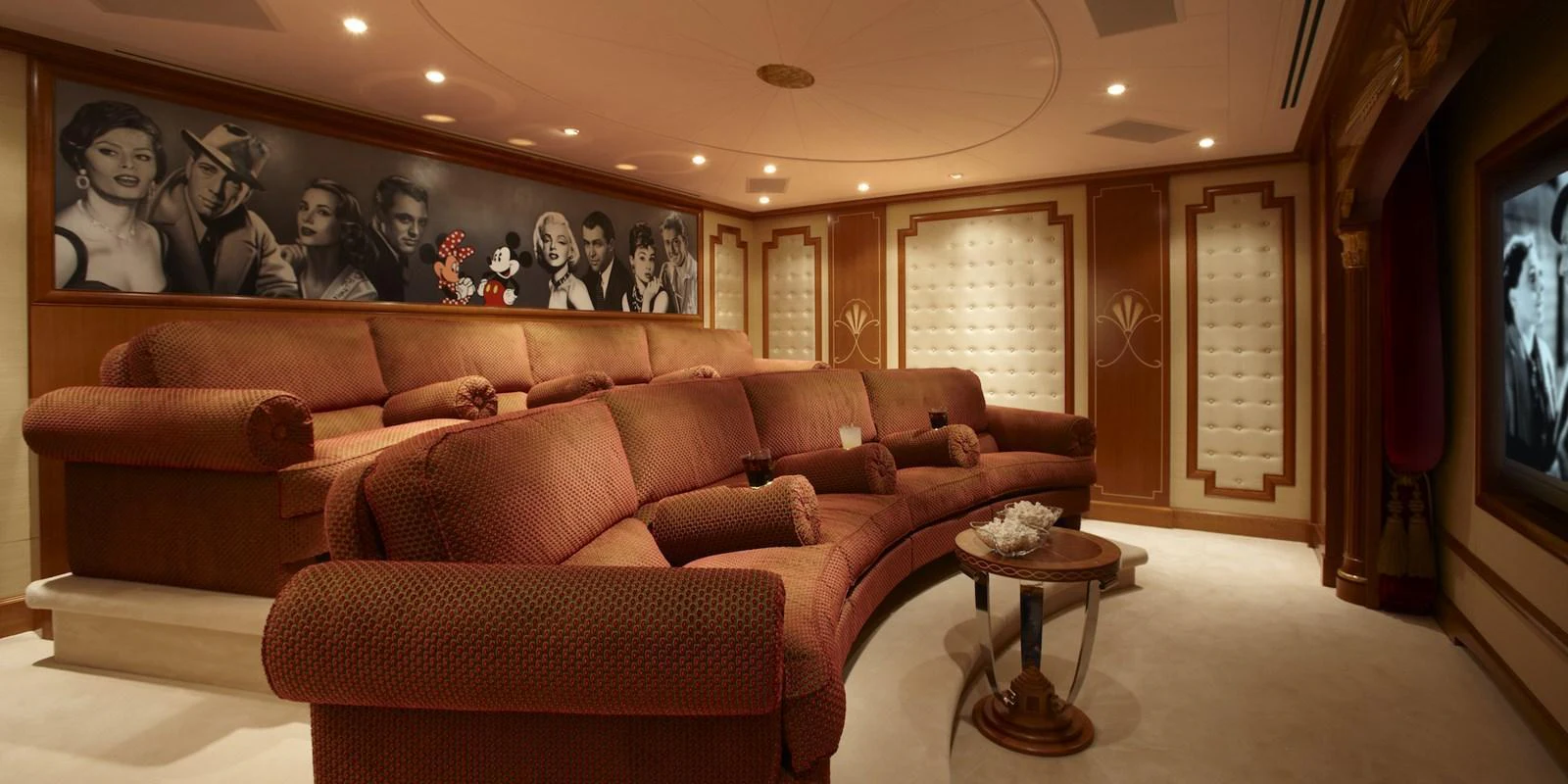 The yacht's theater room features plush seating and a classic movie-themed decor. aboard LADY CHRISTINE Yacht for Sale