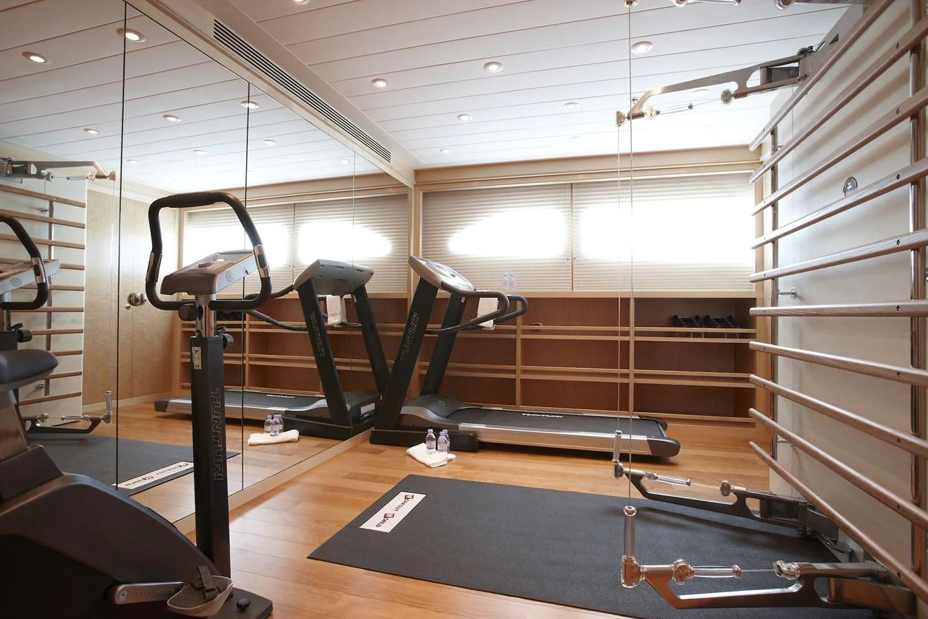 The yacht features a well-equipped gym with modern fitness equipment and ample natural light. aboard LADY CHRISTINE Yacht for Sale