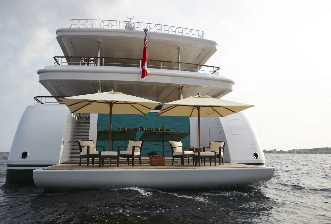 The yacht's aft deck features a spacious lounging area with elegant umbrellas and comfortable seating, perfect for relaxation on the water. aboard LADY CHRISTINE Yacht for Sale