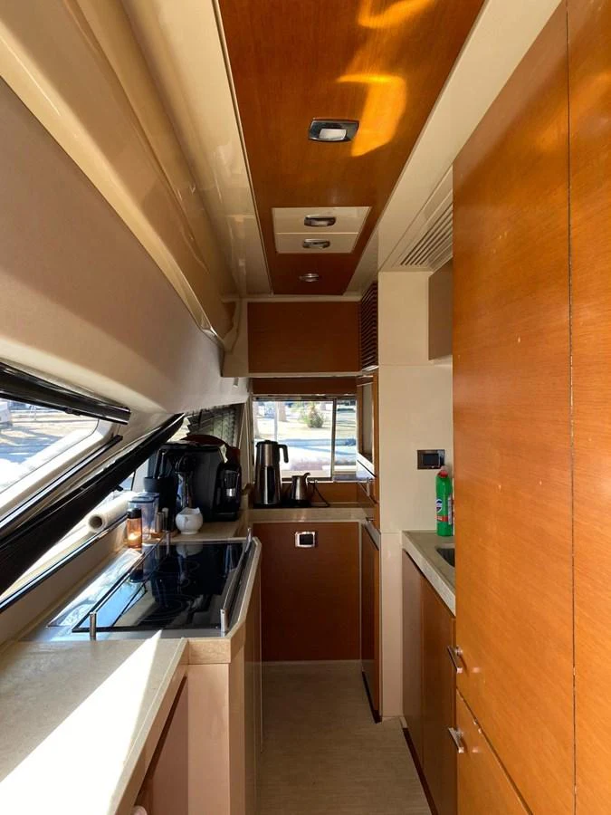 The yacht's galley features modern appliances and ample counter space, bathed in natural light. aboard NE SEL Yacht for Sale