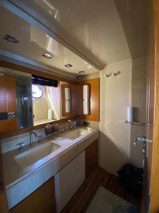 The yacht's bathroom features a double sink vanity with modern fixtures and ample lighting. aboard NE SEL Yacht for Sale