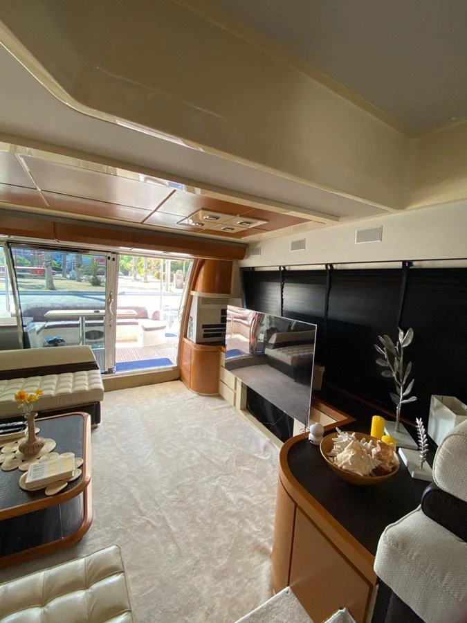 The salon features a modern and inviting space with comfortable seating and a large TV. aboard NE SEL Yacht for Sale