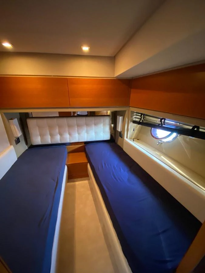The twin stateroom features two comfortable beds with a modern and cozy design. aboard NE SEL Yacht for Sale