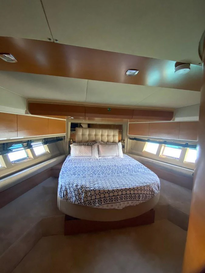 A cozy stateroom with a comfortable bed and ample natural light from the windows. aboard NE SEL Yacht for Sale